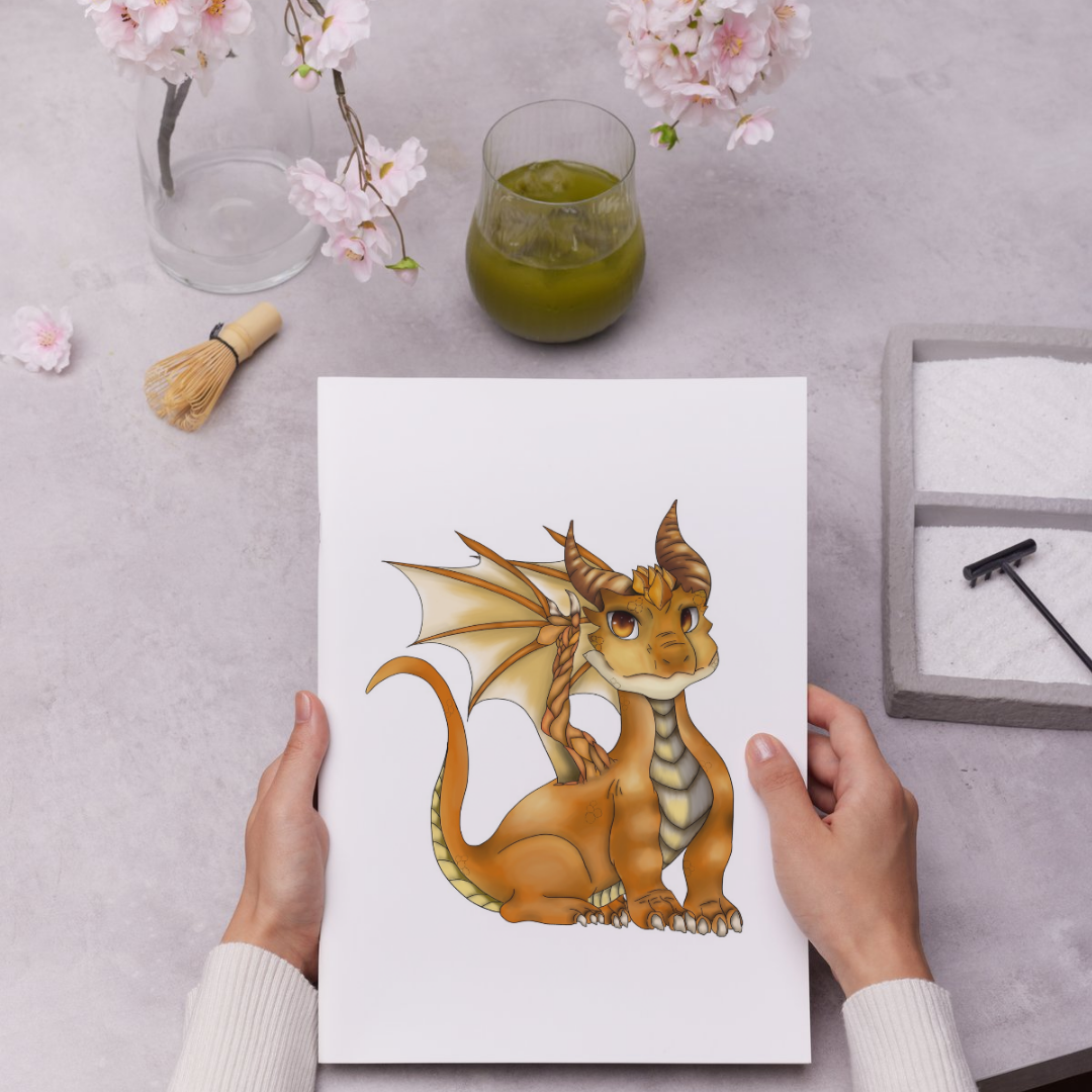 Person holding a card with a dragon illustration on a table with a glass of green tea and cherry blossoms.