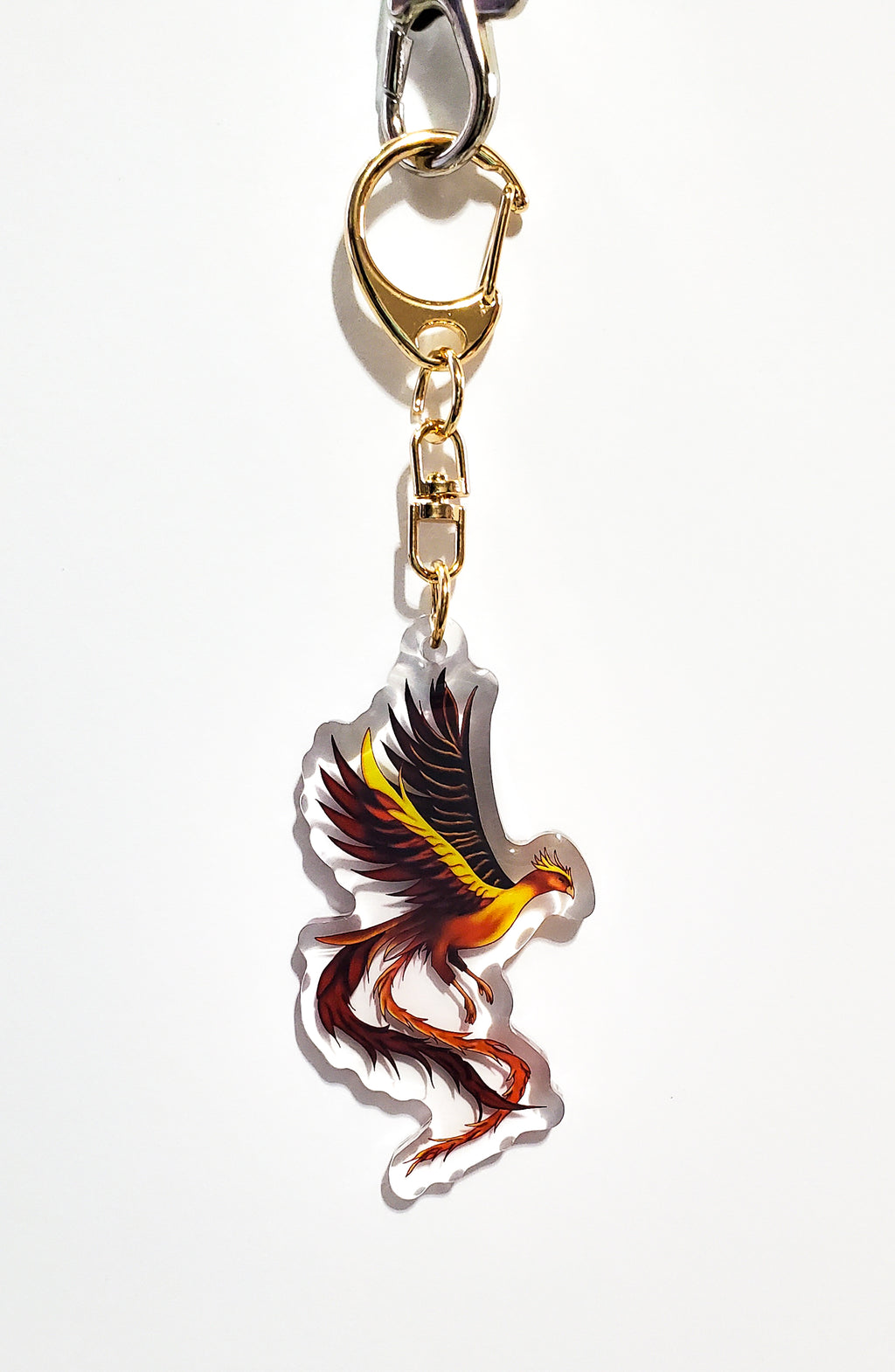 Keychain with a colorful phoenix design on a white background