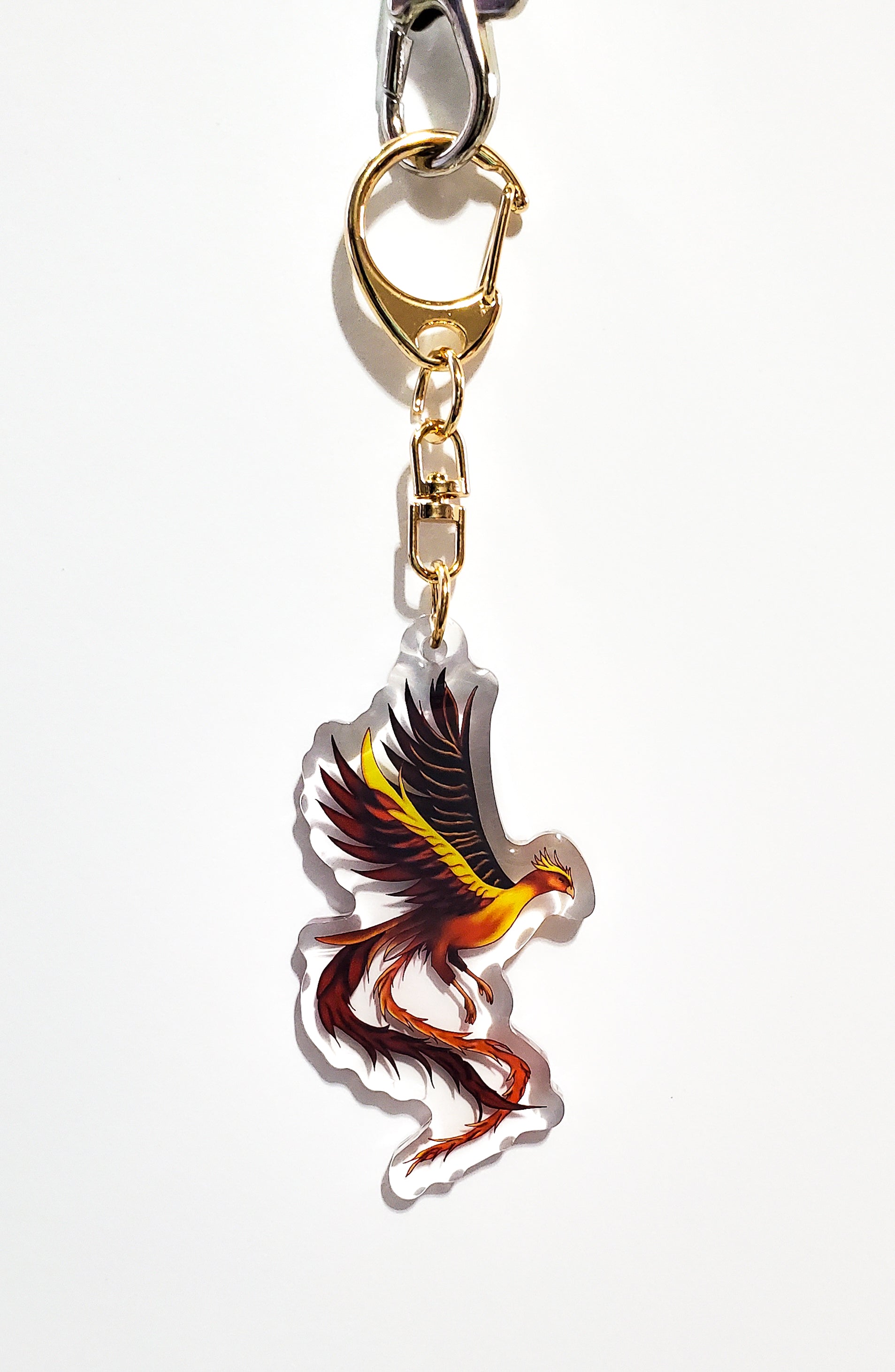 Keychain with a colorful phoenix design on a white background