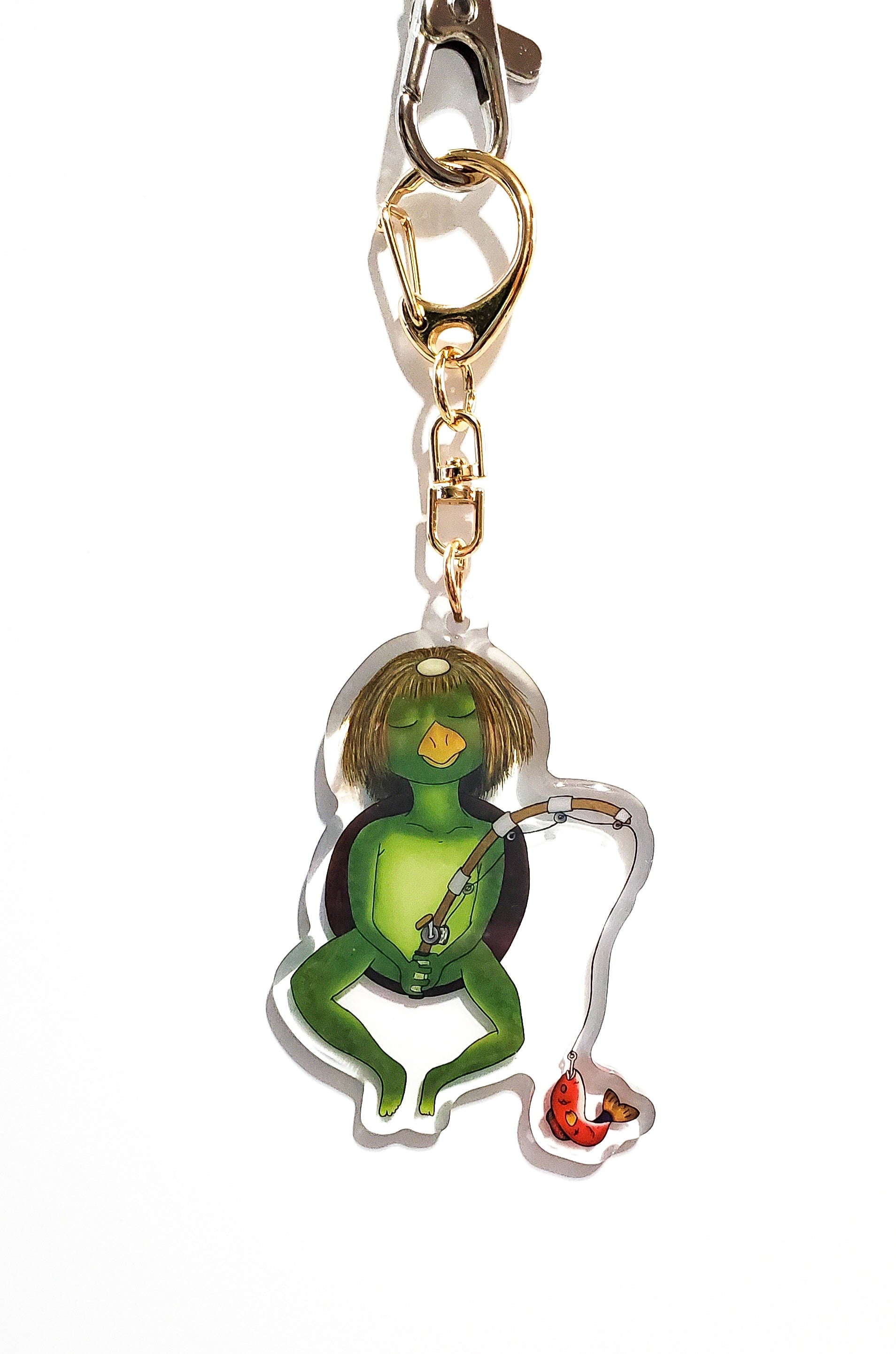 Kappa character keychain with gold chain on a white background
