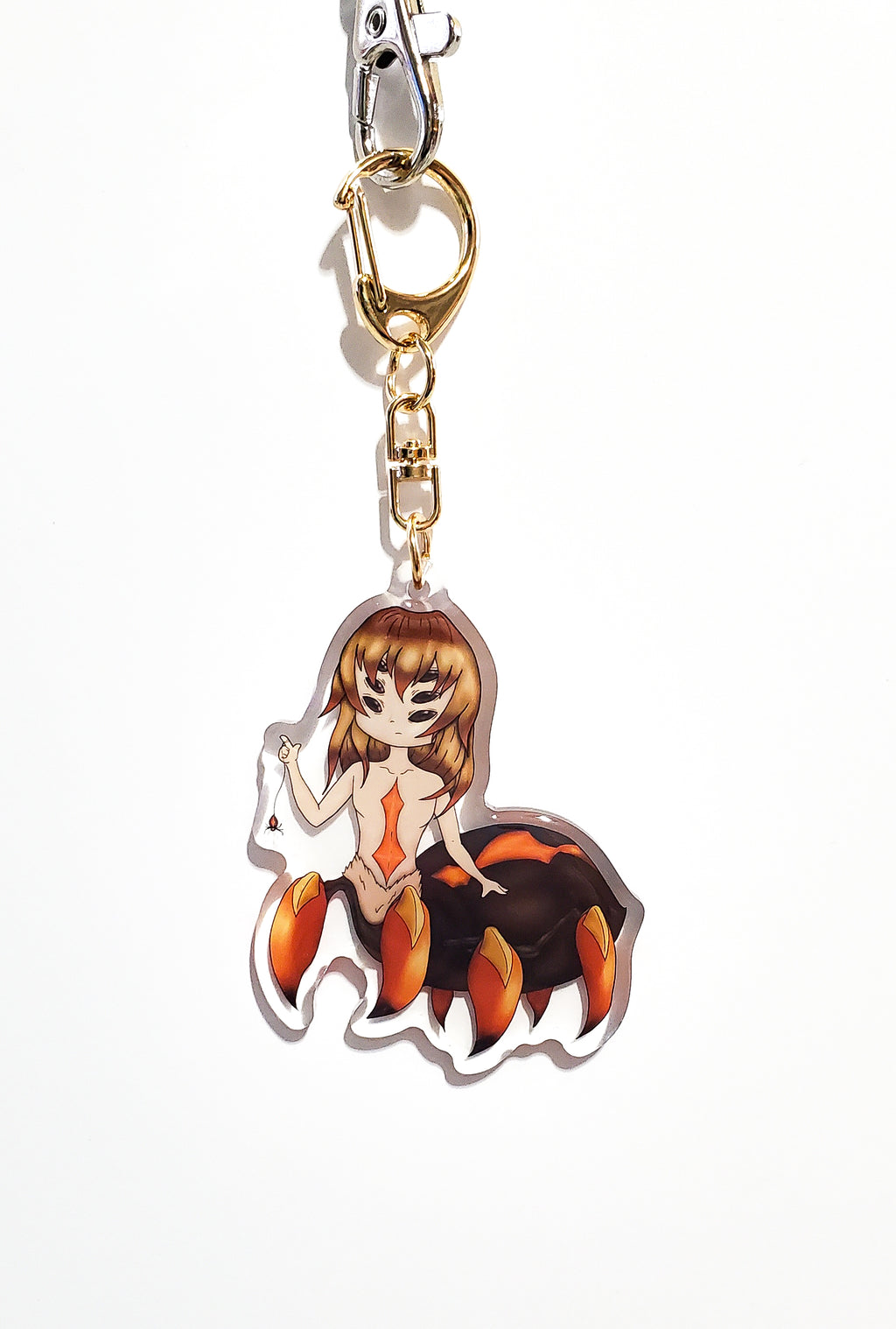Keychain with a spider woman character on a white background