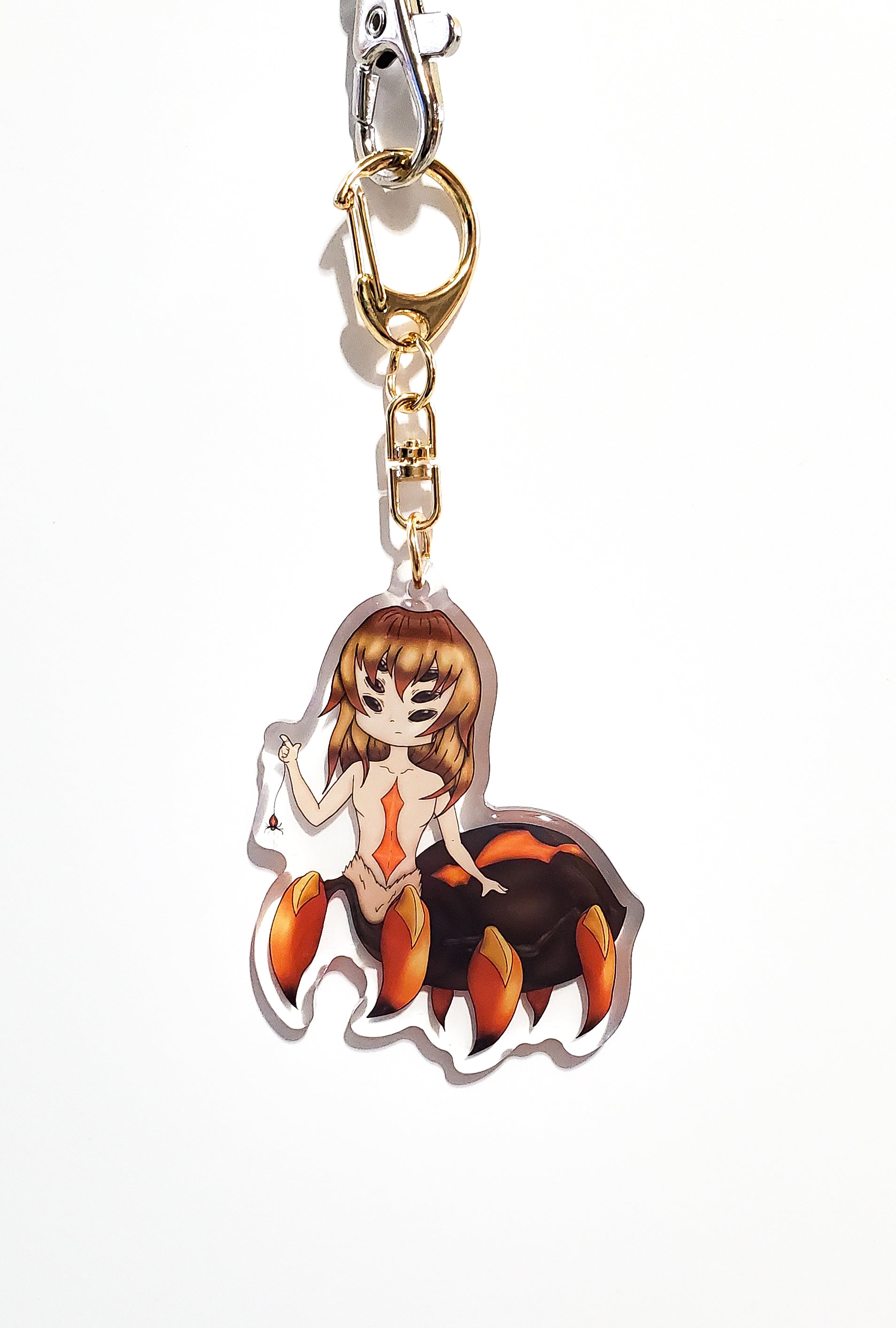 Keychain with a spider woman character on a white background
