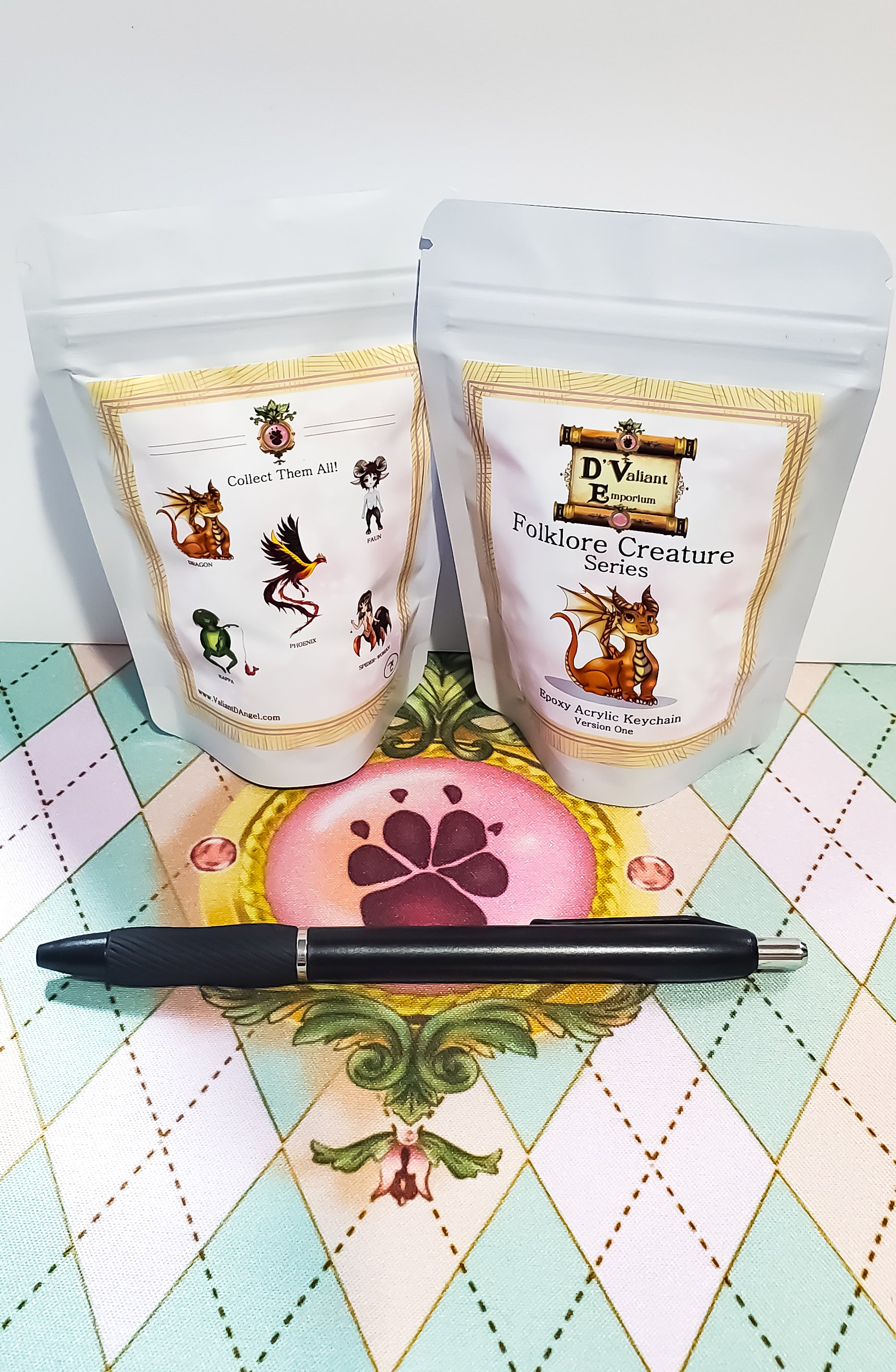 Two packages labeled 'Folklore Creature Series' on a decorative surface with a pen.