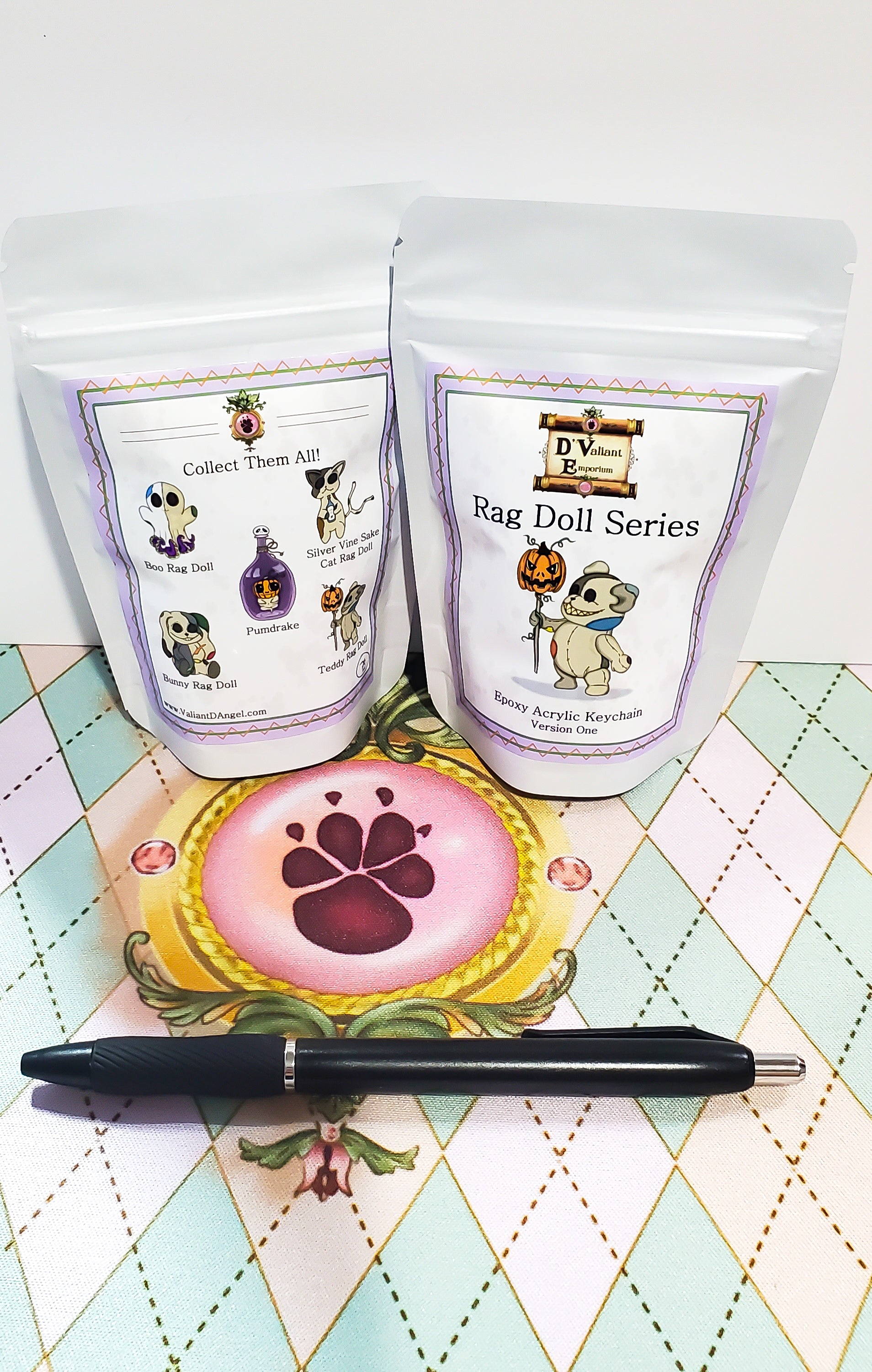 Two bags labeled 'Rag Doll Series' with a decorative item and pen on a patterned surface.